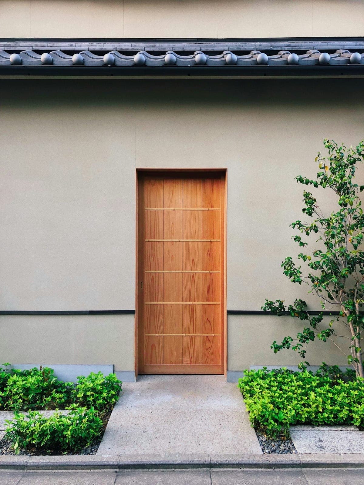Heavy plank wood main doors with long pull handles