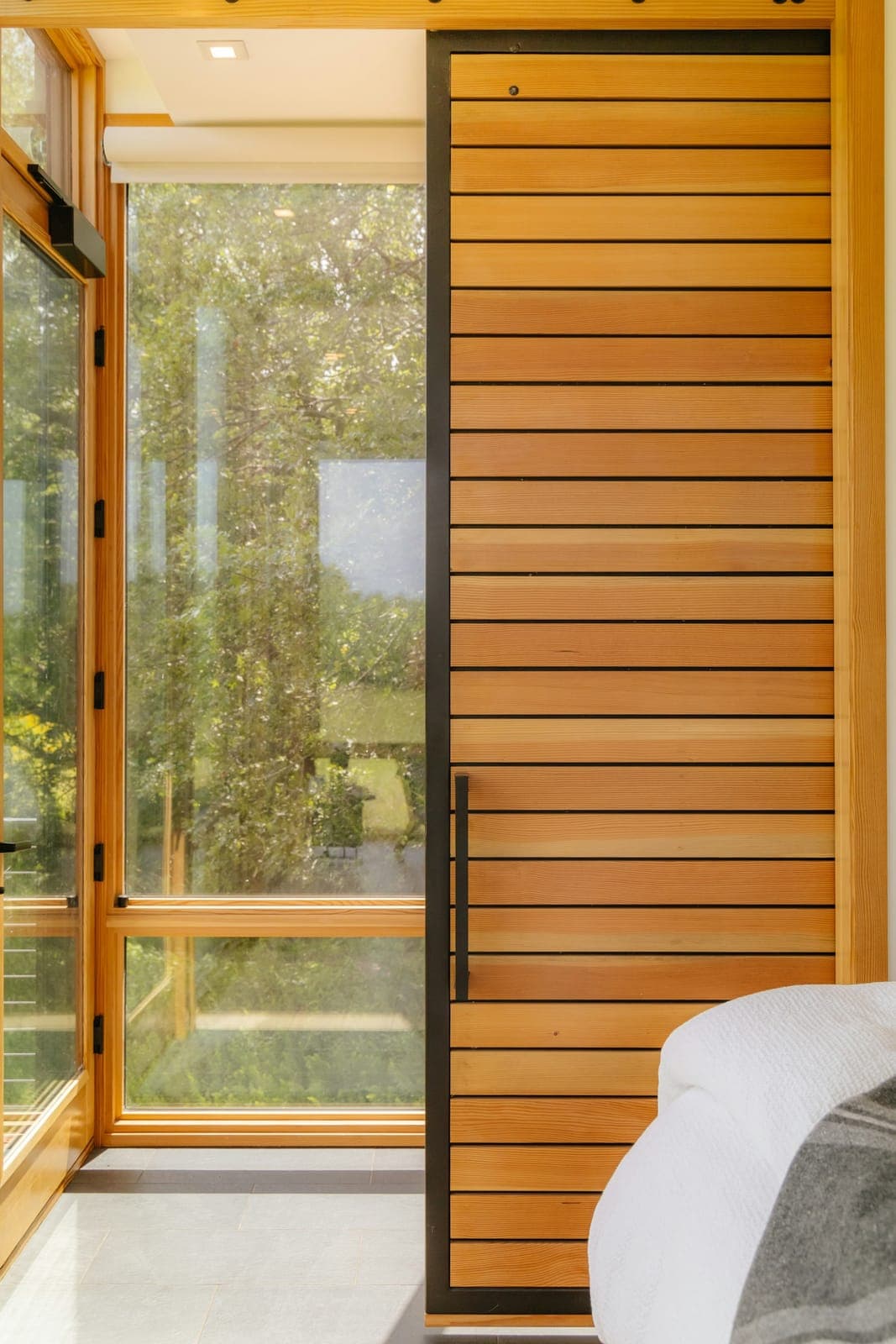 Modern slatted wood door with glass